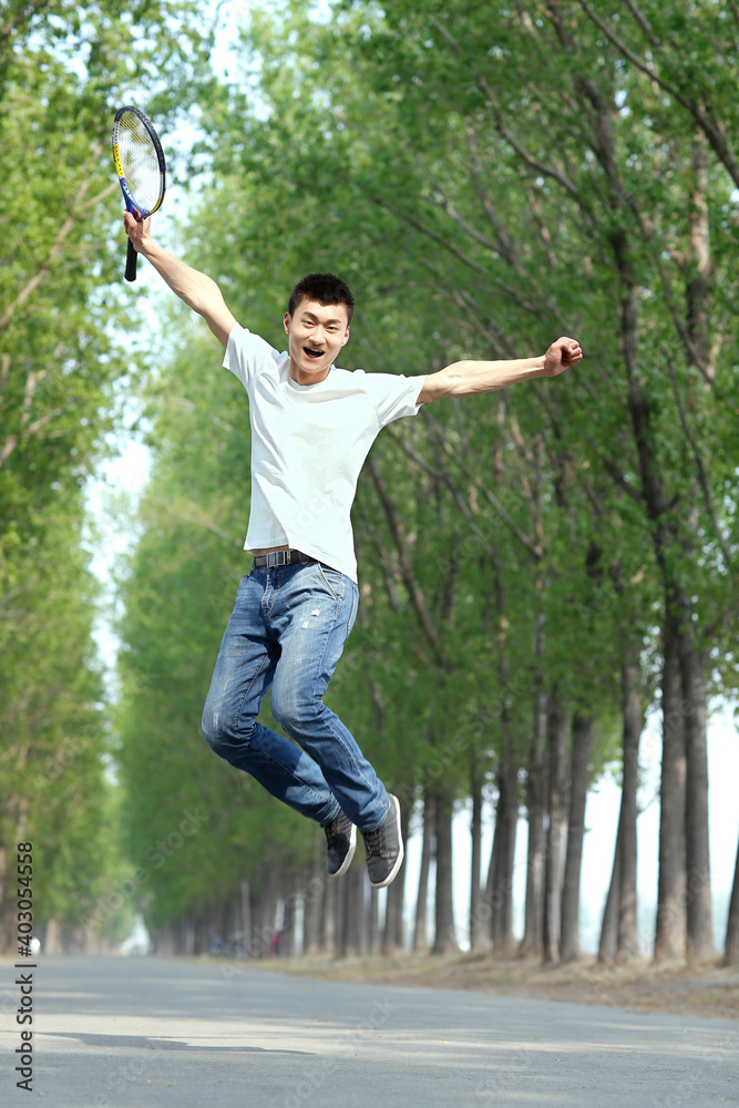 The young man jumping in the park 