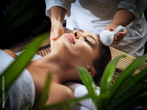 portrait of young beautiful woman in spa environment.   photo