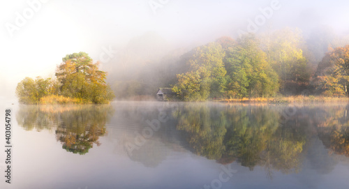 Misty Morning beside Rydal Water in the Lake District, looking towards a quaint boathouse