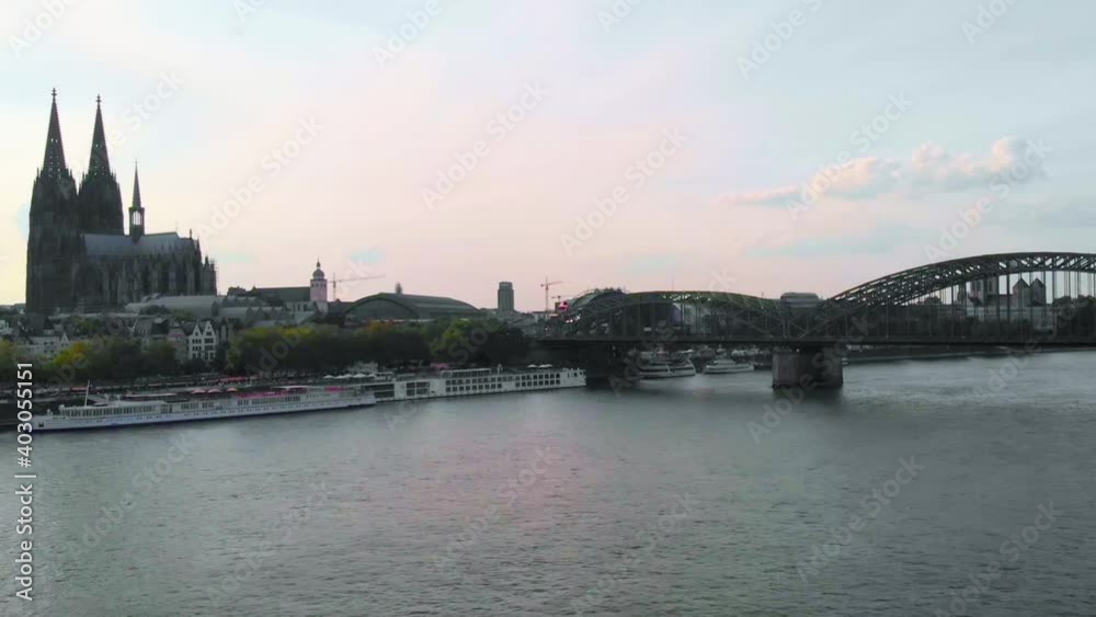 Aerial view over the Rein river towards ferries and the Hohenzollern Bridge, in Cologne, Germany - low, drone shot Aerial view over the Rein river towards ferries and the Hohenzollern Bridge, in Cologne, Germany - low, drone shot