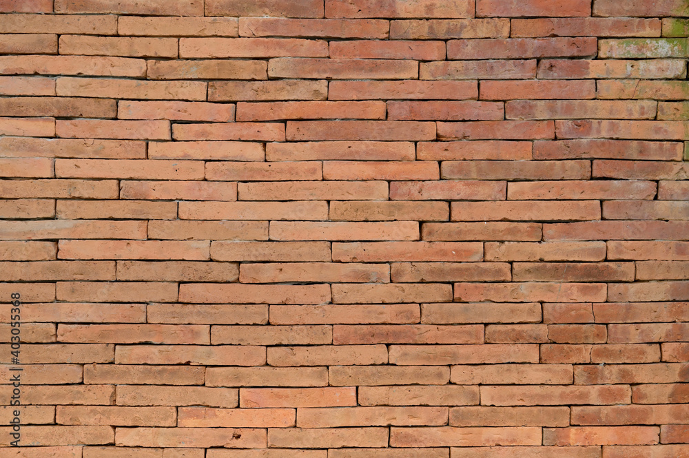 Fototapeta premium Long and uneven red brick wall pattern