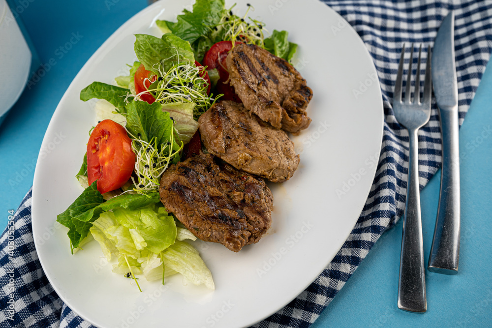 Meat with vegetables. Pork medallions. Grilled meat. Cutlets close-up. Beef. Meat with vegetables. Pork medallions. Grilled meat. Cutlets close-up. Beef.