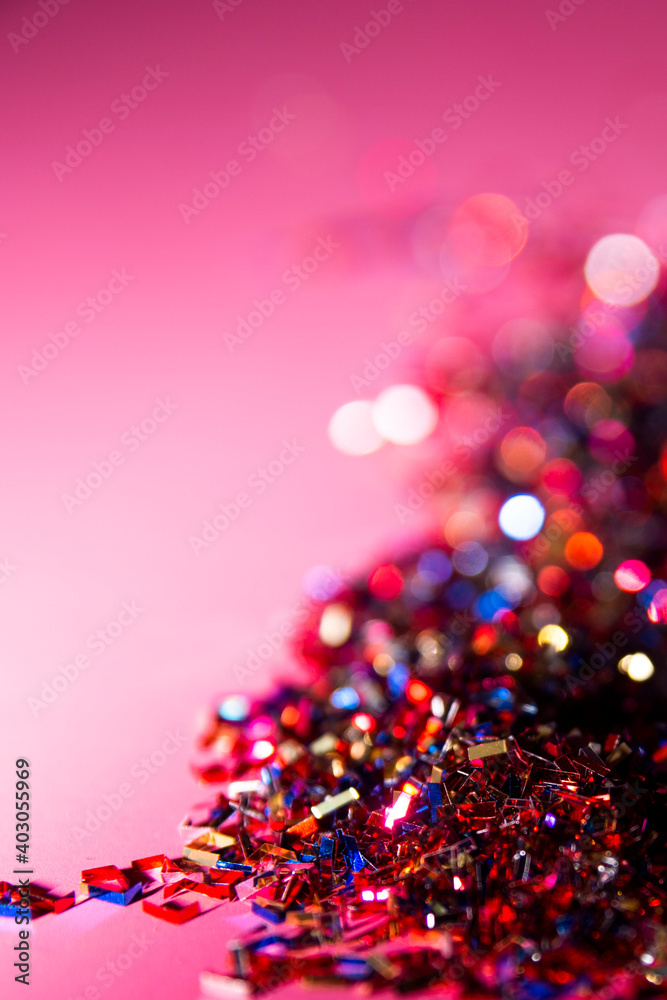 Close-up of a bunch of shiny confetti on pink background. Carnival and party concept. Vertical photography. Copy Space Close-up of a bunch of shiny confetti on pink background. Carnival and party concept. Vertical photography. Copy Space