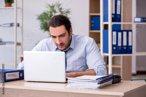 Young male bookkeeper working in the office