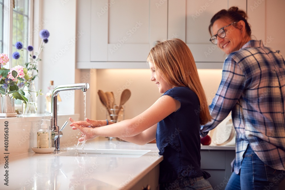 Mother With Daughter Washing Hands With Soap At Home To Stop Spread Of Infection In Health Pandemic Mother With Daughter Washing Hands With Soap At Home To Stop Spread Of Infection In Health Pandemic