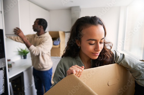Excited Young Couple In New Home Unpacking Removal Boxes In Kitchen Together © Southworks