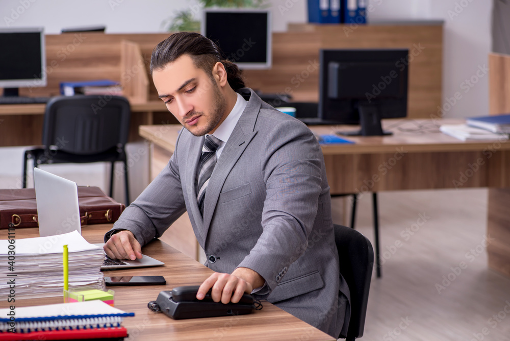 Young male employee working in the office