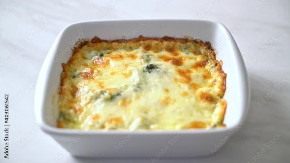 baked spinach lasagna with cheese in white plate