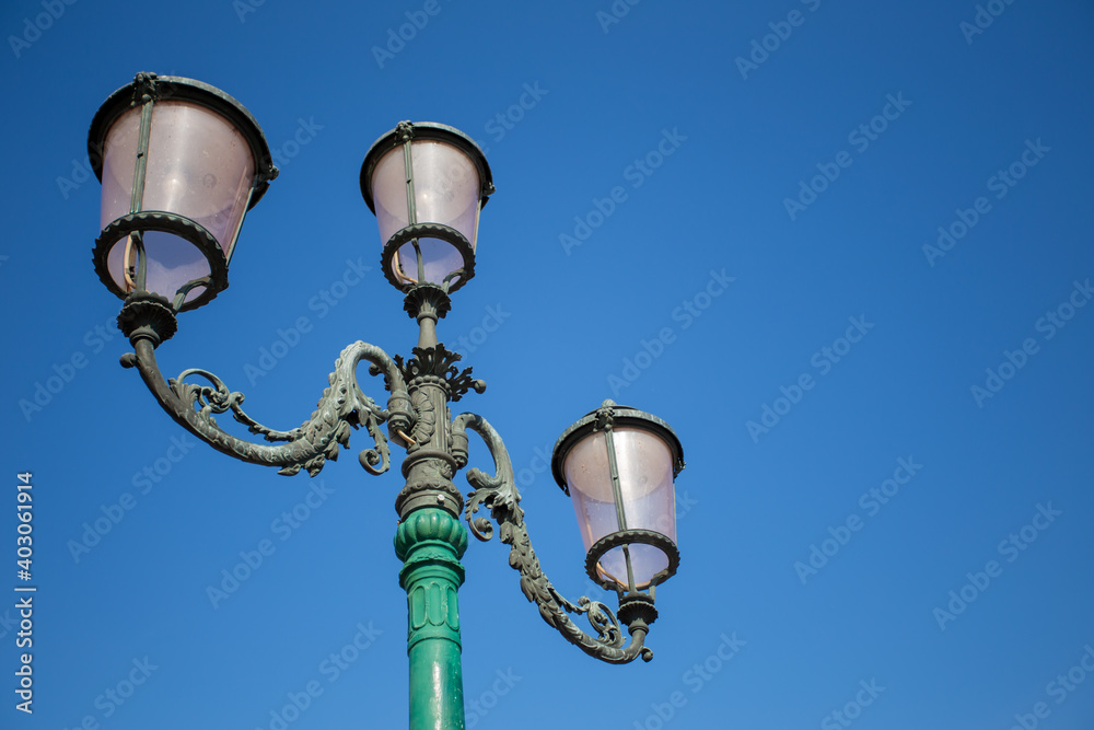 old street lamp on blue sky