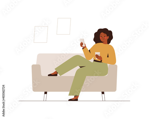 Black businesswoman sits on the couch at home or in the office with a mobile phone at break time. Young dark skin female drinks coffee and using a smartphone. Flat cartoon vector illustration.