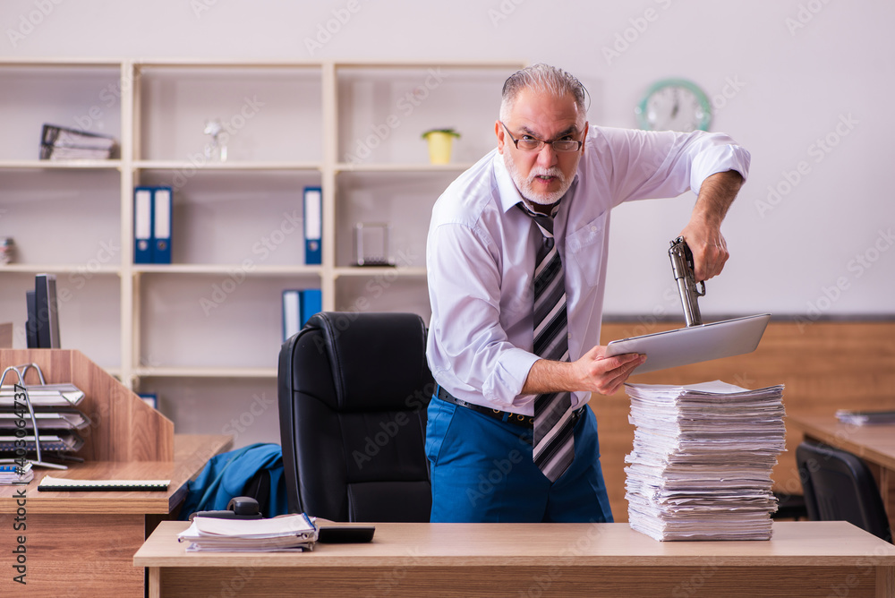 Old male employee unhappy with excessive work in the office