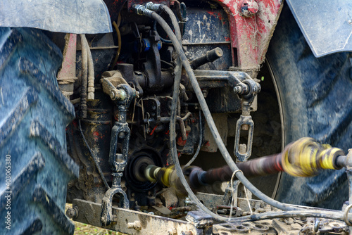 Fotografija Tractor and cardan shaft for coupling equipment, tractor in the field during haymaking