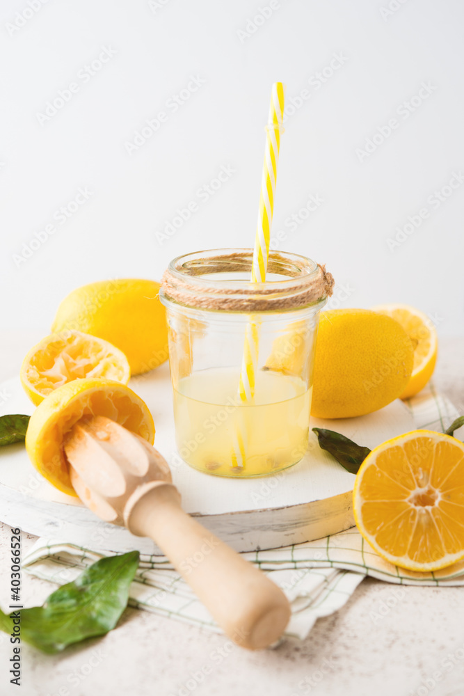 Fototapeta premium Freshly squeezed natural lemon juice in a glass jar on a white background