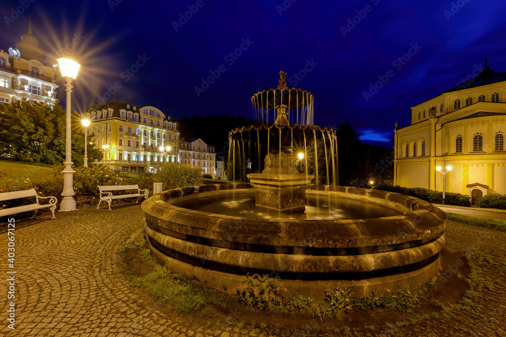 Public fountain in spa park - night photo of Goethe Square in Marianske Lazne (Marienbad) - Czech Republic