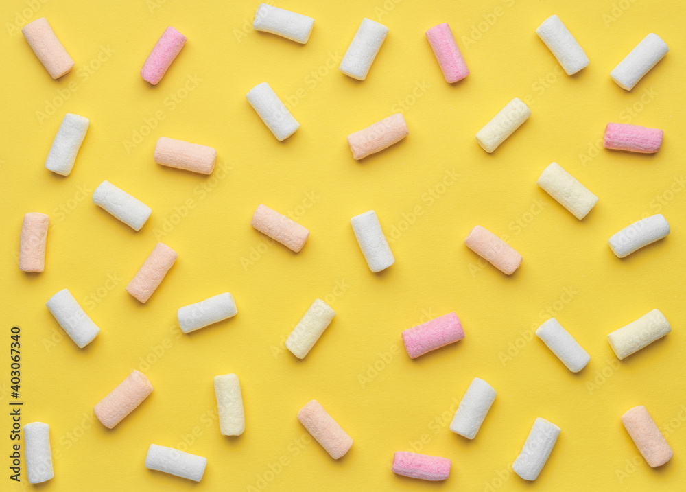 colorful marshmallows on yellow background colorful marshmallows on yellow background