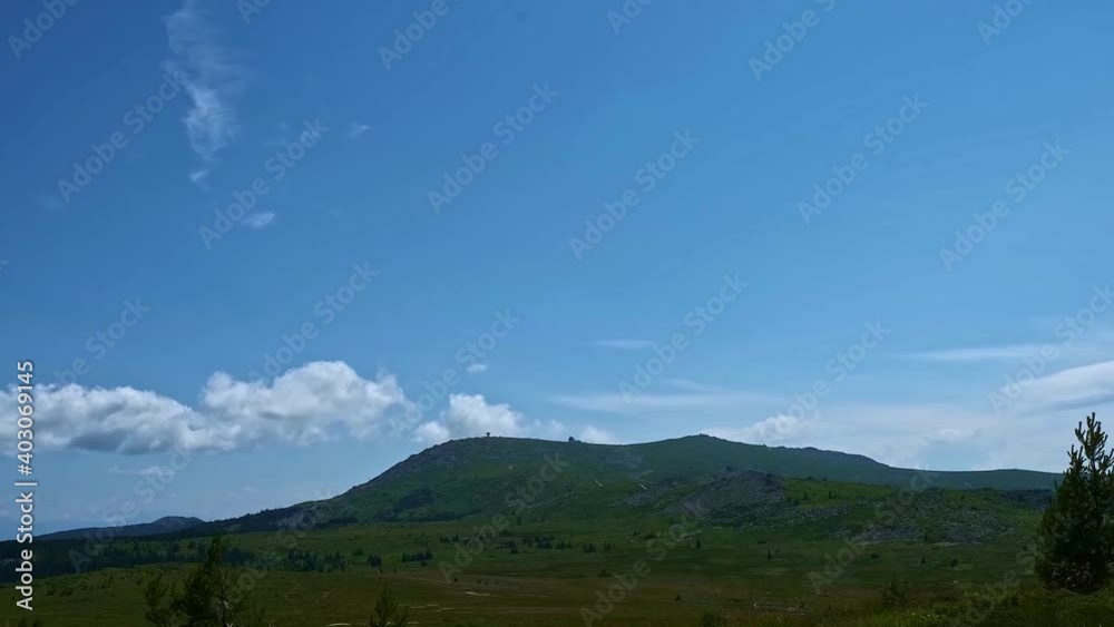Time lapse of clouds on a mountain plateau looking towards a summit Time lapse of clouds on a mountain plateau looking towards a summit