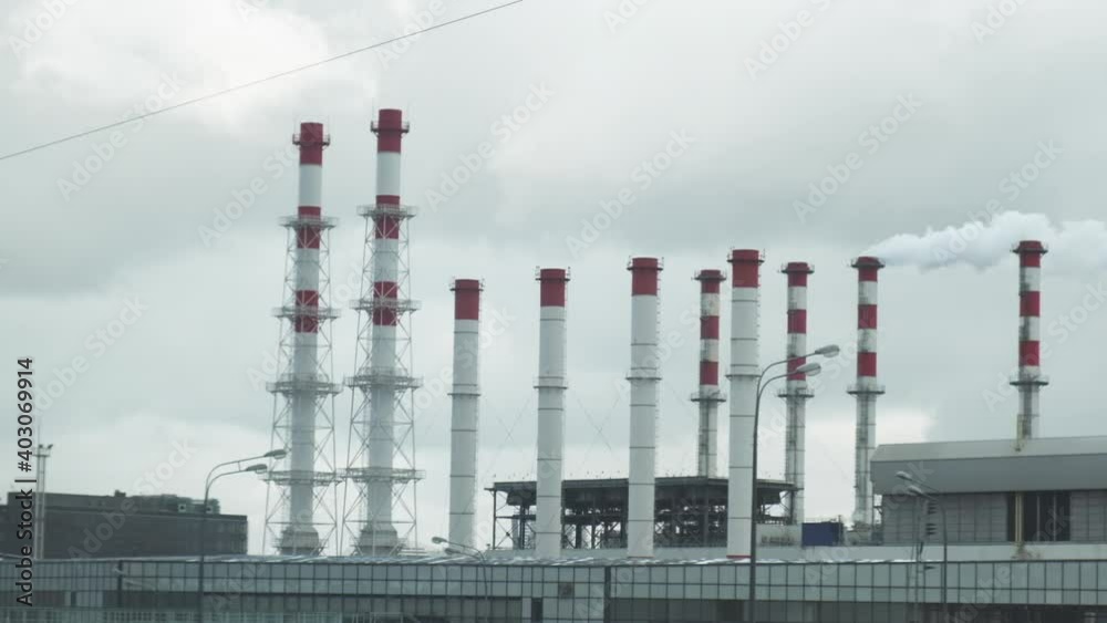 Industrial view from train window. Pipes of the thermal power plant and highways. Pollution of the environment. Industrial view from train window. Pipes of the thermal power plant and highways. Pollution of the environment.