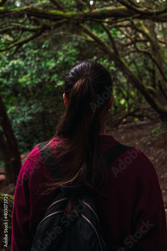 A woman walking through the forest