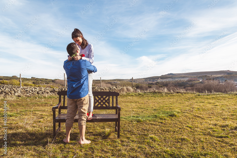 Young couple Hugging, kissing and enjoying spending time together while celebrating Saint Valentine's Day in the countryside. Love san valentin and Relationship concept. Young couple Hugging, kissing and enjoying spending time together while celebrating Saint Valentine's Day in the countryside. Love san valentin and Relationship concept.