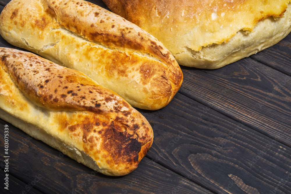 Bakeds loafs of Ukrainian national bread on a black vintage table Bakeds loafs of Ukrainian national bread on a black vintage table
