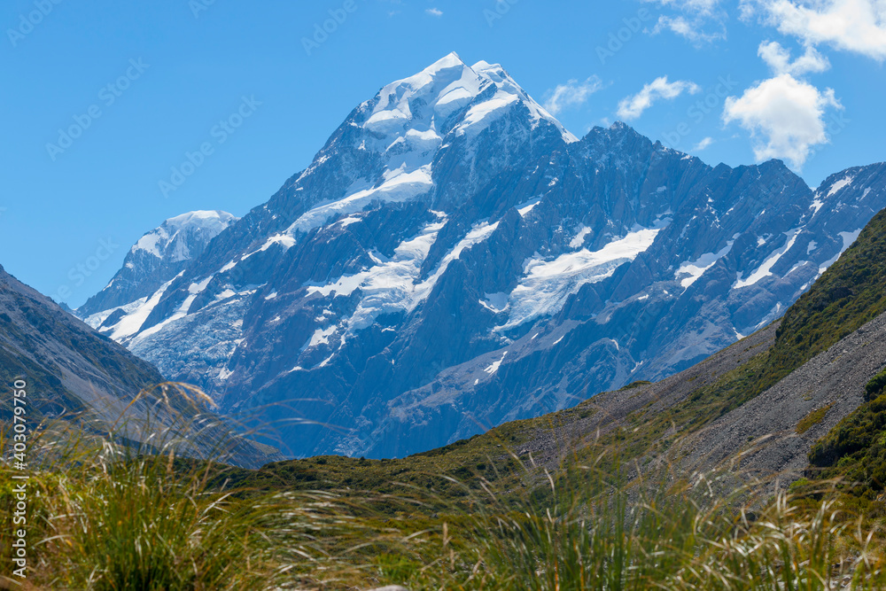  sunshine strikes snow-capperd Mount Cook byond valley below