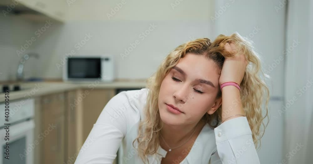 Bored student holds head on hand nodding and yawns looking into computer camera at online lecture staying home at covid isolation Bored student holds head on hand nodding and yawns looking into computer camera at online lecture staying home at covid isolation