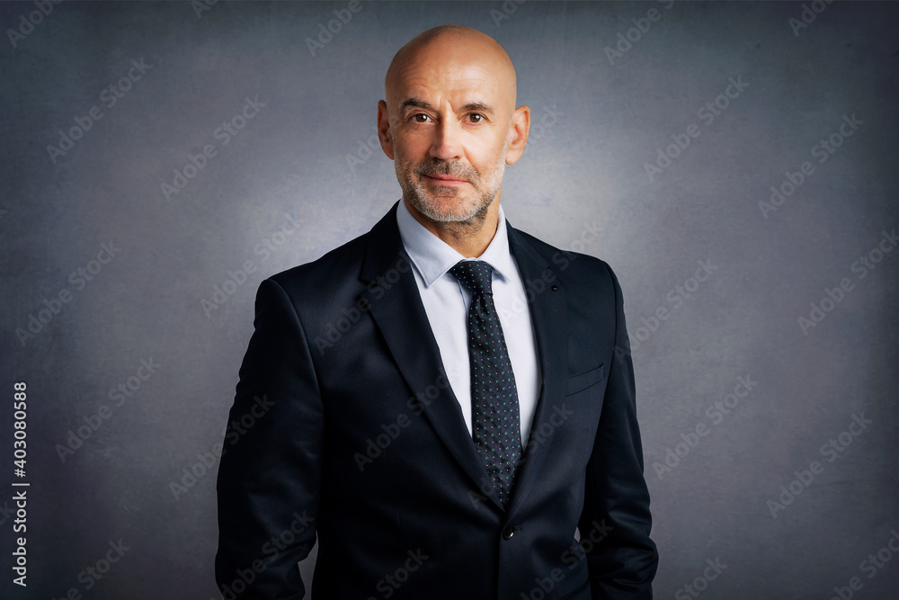 Confident businessman portrait while wearing suit and standing at isolated background Confident businessman portrait while wearing suit and standing at isolated background