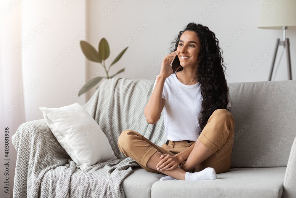 Happy brunette woman having conversation on phone Happy brunette woman having conversation on phone
