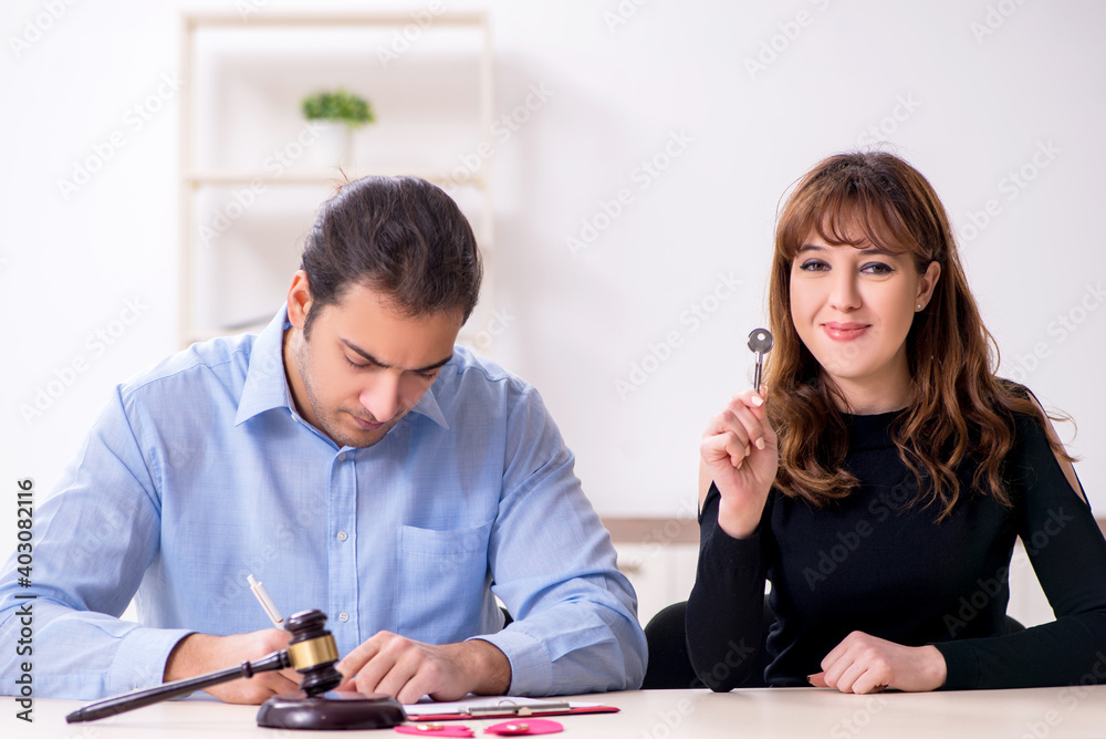 Young pair in courthouse in divorcing concept Young pair in courthouse in divorcing concept