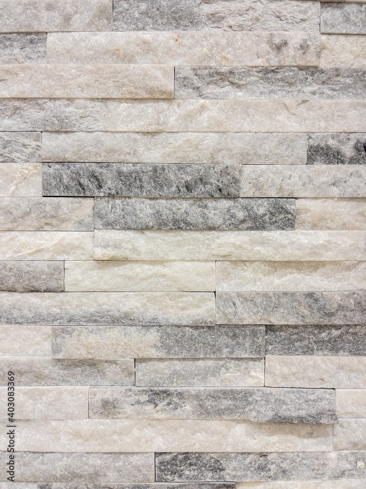 Texture - tiles for floor and wall imitating a wall of hewn uneven stone assembly