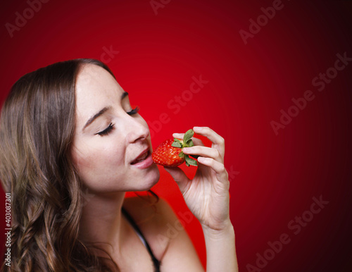 Beautiful Woman Eating Strawberry fruit