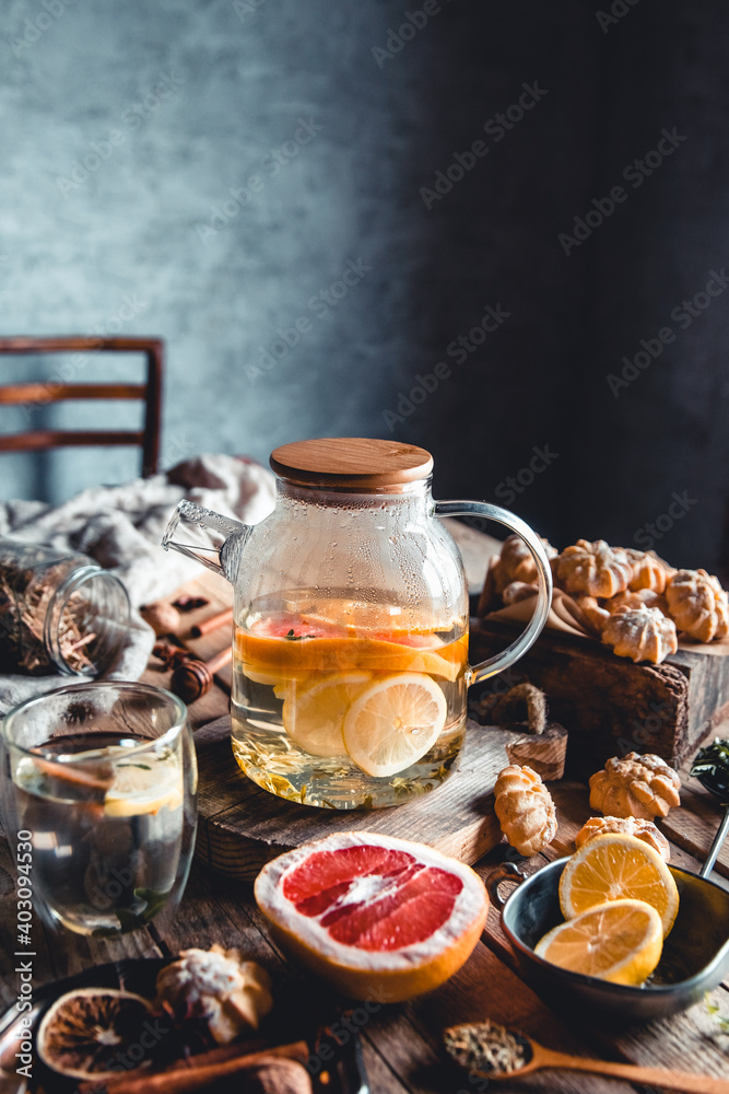 Hot tea with slices of fresh grapefruit on wooden tablet. Healthy drink, Eco, vegan Hot tea with slices of fresh grapefruit on wooden tablet. Healthy drink, Eco, vegan