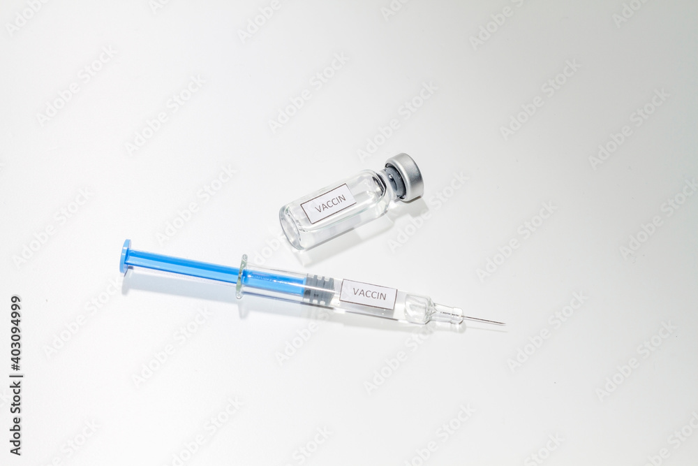Covid-19. A vaccine vial with a syringe ready to inject to vaccinate. The syringe and vial are labeled with the word Covid-19. A vaccine vial with a syringe ready to inject to vaccinate. The syringe and vial are labeled with the word