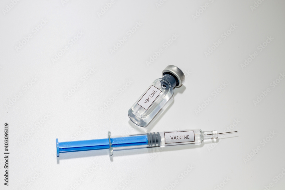 Covid-19. A vaccine vial with a syringe ready to inject to vaccinate. The syringe and vial are labeled with the word vaccine in English. Covid-19. A vaccine vial with a syringe ready to inject to vaccinate. The syringe and vial are labeled with the word vaccine in English.