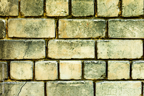 Texture of a brick wall with cracks and scratches which can be used as a background