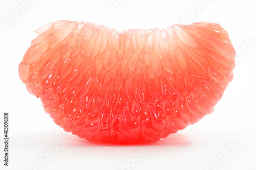 Fototapeta juicy red grapefruit slice on a white
