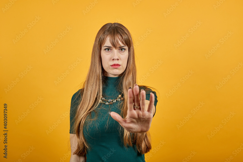 Palm arm raised air angry look straight you will not pass through facial expression harsh. Serious looking strict demands stop, pulls hand forward camera, says no, disagrees, frowns face, warning Palm arm raised air angry look straight you will not pass through facial expression harsh. Serious looking strict demands stop, pulls hand forward camera, says no, disagrees, frowns face, warning