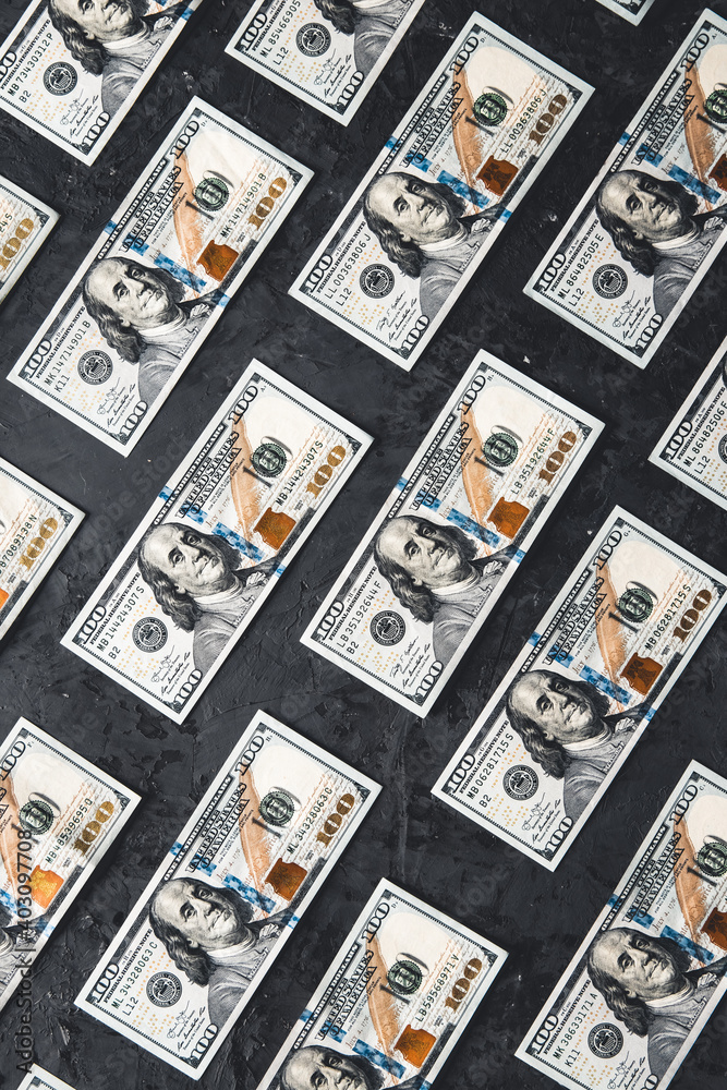 One hundred dollar bills are creatively laid out. Business concept, development perspective. One hundred dollar bills are creatively laid out. Business concept, development perspective.