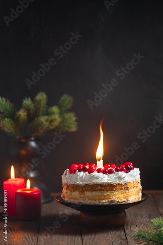Celebration table festive cake with sparkler on the dark background with cranberries homemade bakery