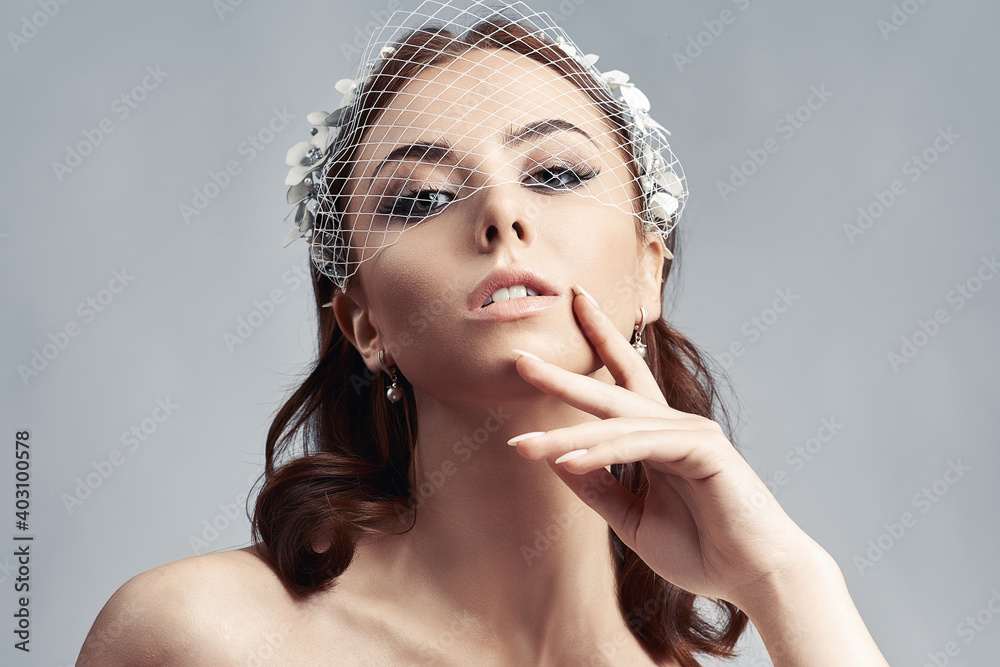 Portrait of a bride with birdcage veil.