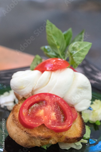Tomato, mozzarella and basil bruschetta, Italian recipe. Selective focus