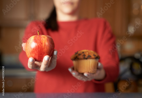 Cuadro en lienzo Cropped portrait of woman offering you between junk food and natural healthy org