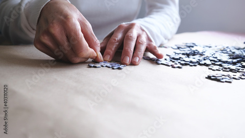 Selective focused woman holding jigsaw puzzle.Woman doing puzzle.anti-dementia