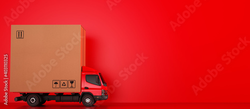 Obraz na płótnie Big cardboard box package on a red truck ready to be delivered