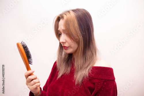 Girl combing hair isolated on white background