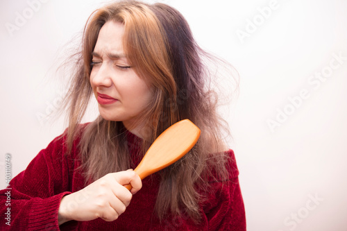 Girl combing hair isolated on white background
