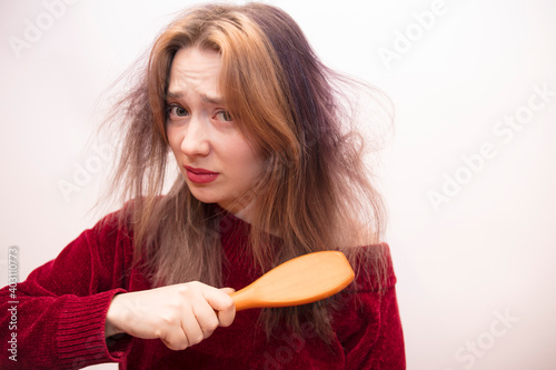 Girl combing hair isolated on white background