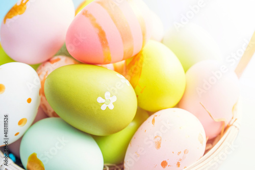 Easter basket filled with painted Easter eggs. Colorful painted Easter eggs in basket