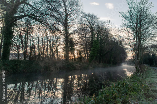 Fototapeta Naklejka Na Ścianę i Meble -  Foggy Sunrise at Ancient Irish Canal