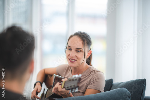 women playing guitar at ome